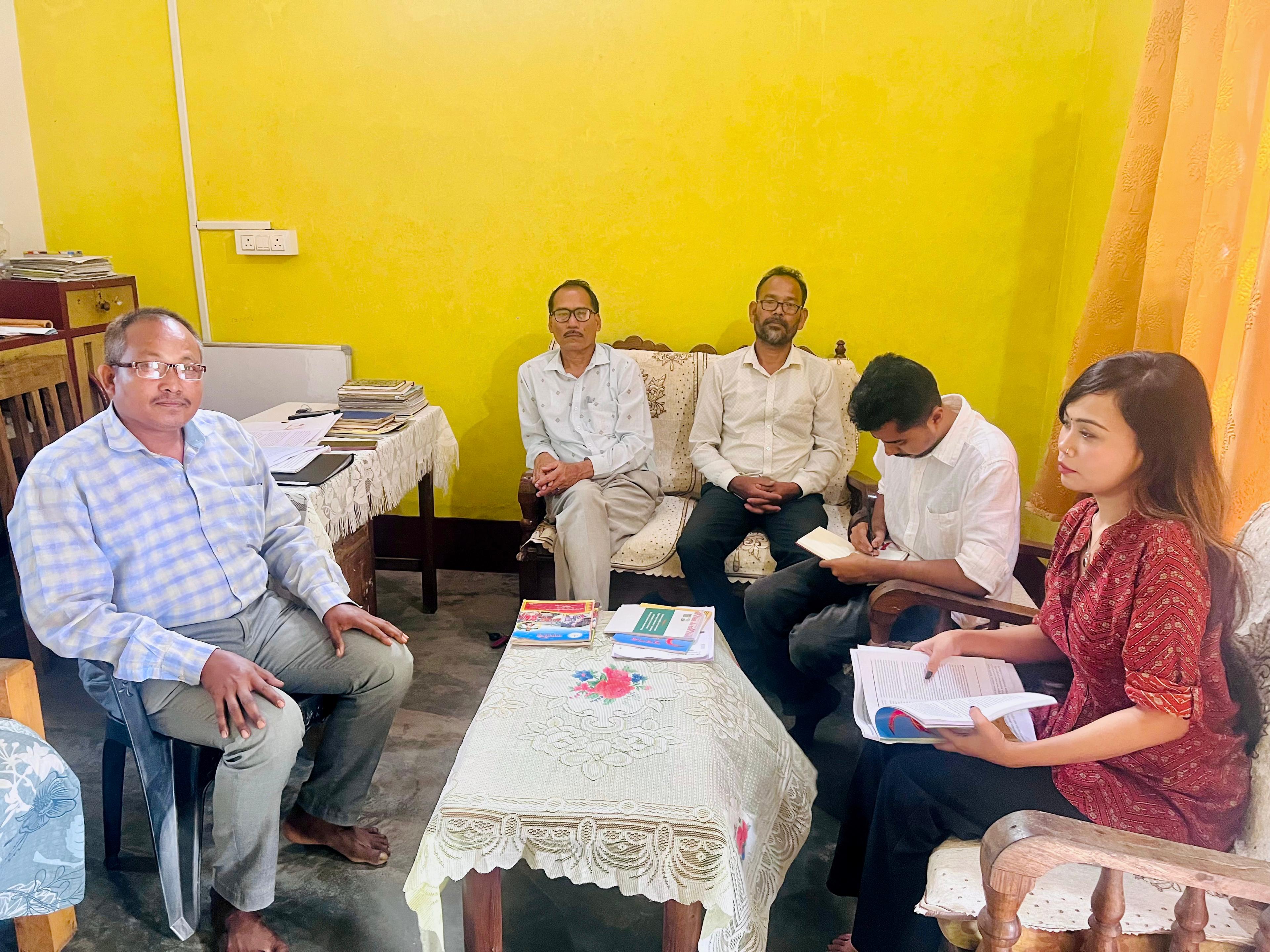 Field team in discussion during a survey visit
