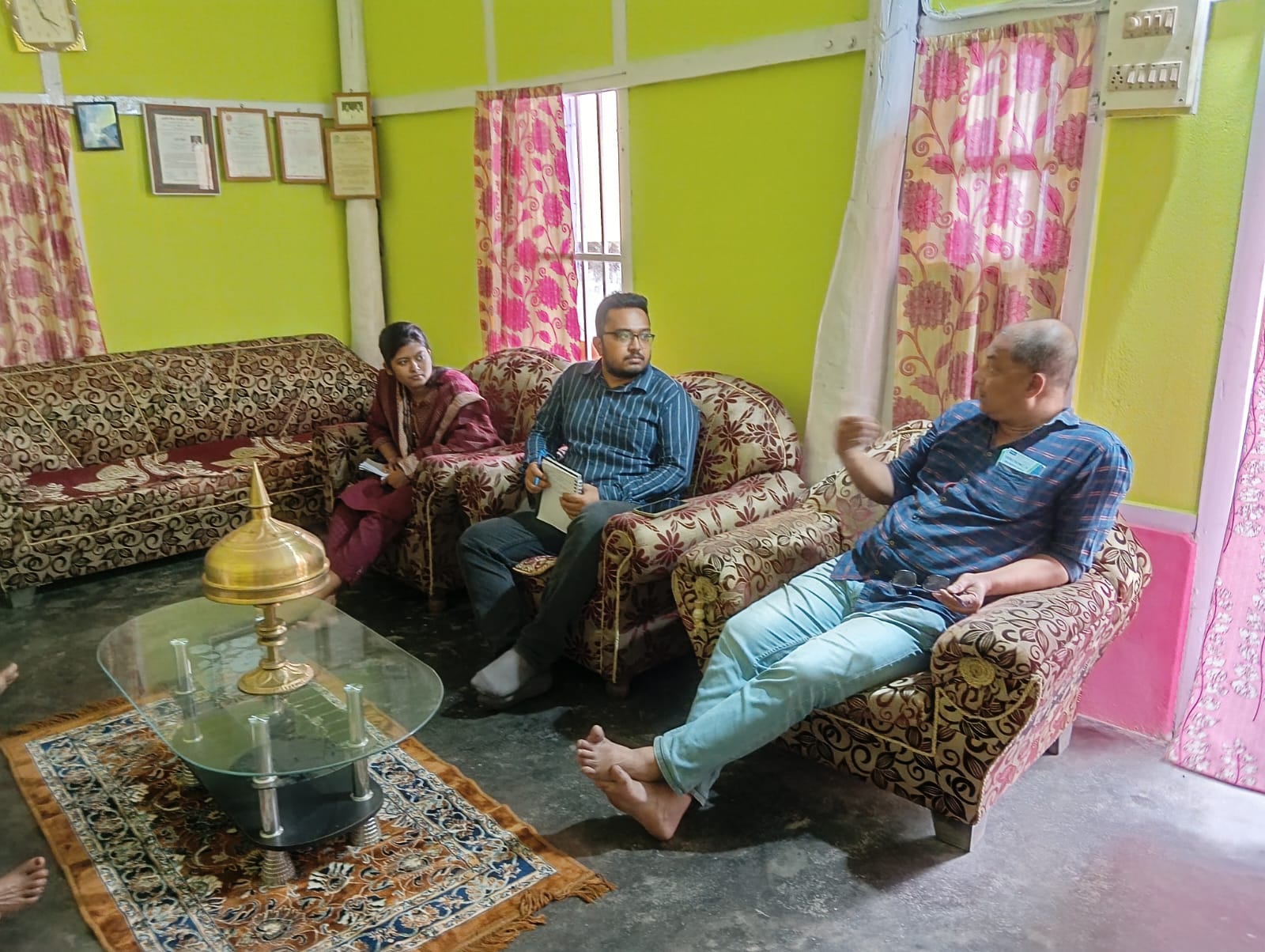 Survey team speaking with respondents inside a household